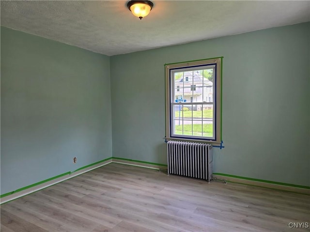 343 N Peterboro St, Lenox, NY 13032 - spare room with radiator heating unit, wood finished floors, baseboards, and a textured ceiling