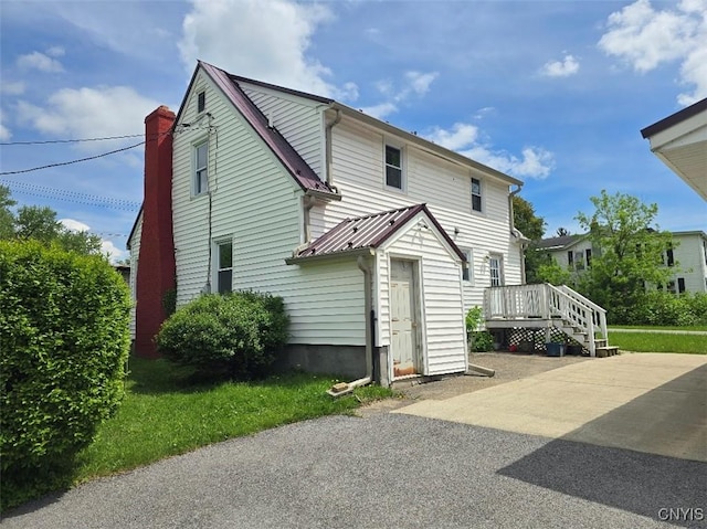 343 N Peterboro St, Lenox, NY 13032 - view of home's exterior with a deck, metal roof, and a chimney