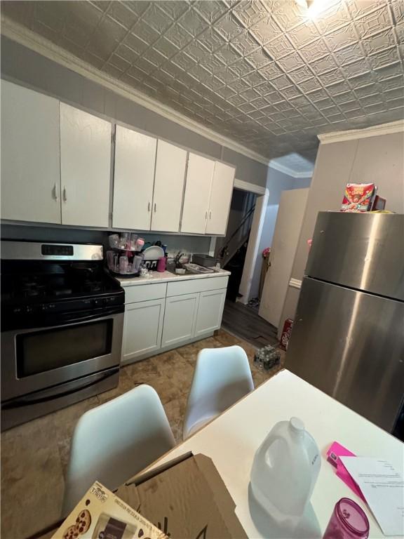 408 Glenwood Ave, Rochester, NY 14613 - kitchen featuring appliances with stainless steel finishes, crown molding, white cabinetry, light countertops, and a sink