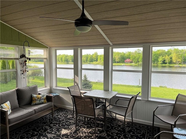 sunroom featuring wood ceiling, a water view, vaulted ceiling, healthy amount of natural light, and ceiling fan