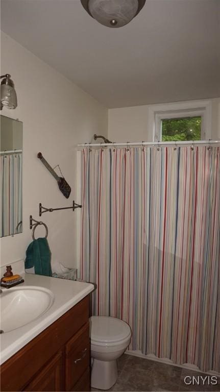 bathroom featuring vanity, toilet, and tile patterned floors