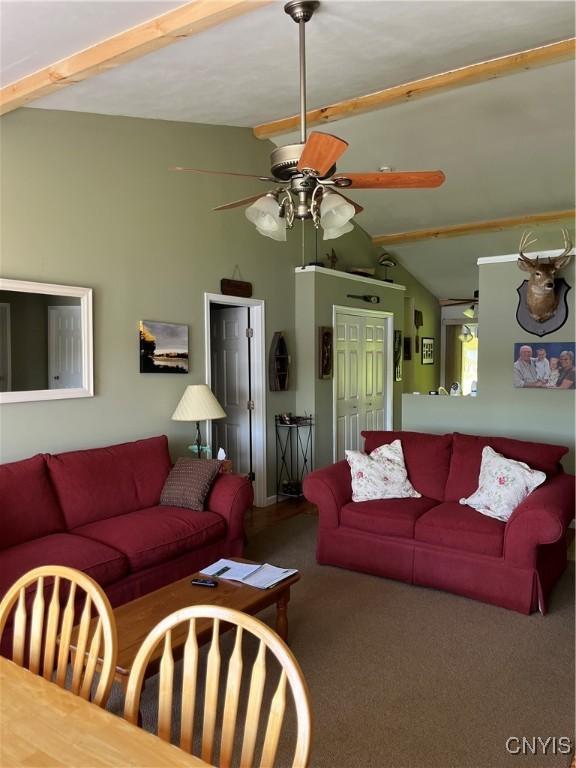 living area featuring carpet and ceiling fan