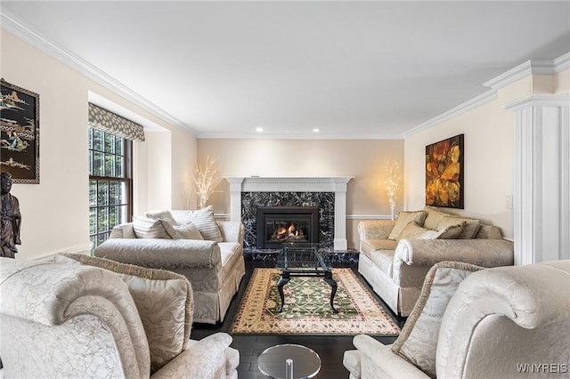 living room with crown molding, wood finished floors, a high end fireplace, and recessed lighting