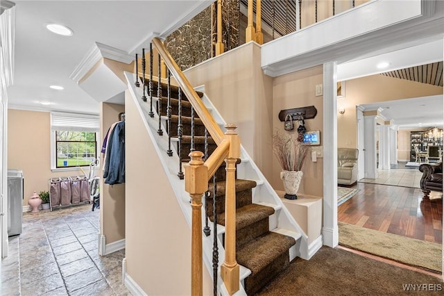 stairway with ornamental molding, baseboards, and recessed lighting