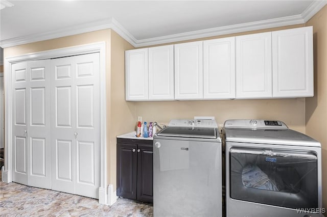 washroom with cabinet space, independent washer and dryer, ornamental molding, and baseboards