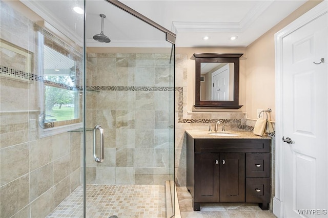 full bathroom featuring crown molding, a shower stall, vanity, and recessed lighting