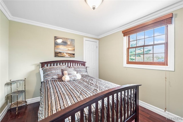 bedroom with baseboards, crown molding, and wood-type flooring