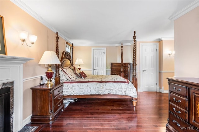 bedroom with dark wood-style floors, a fireplace, baseboards, and crown molding