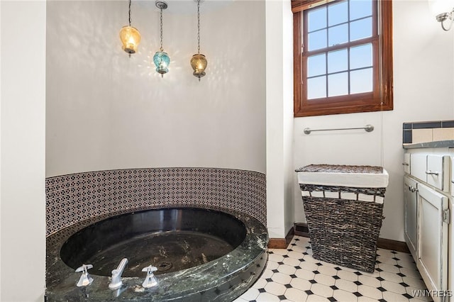 full bath with a bathtub, baseboards, and tile patterned floors