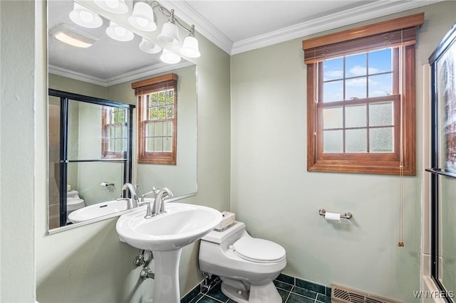 bathroom featuring toilet, a shower with shower door, tile patterned flooring, a sink, and ornamental molding