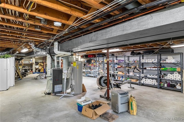 unfinished basement featuring gas water heater and heating unit
