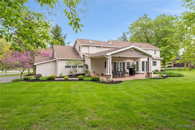 rear view of house featuring a lawn, a patio, and a ceiling fan