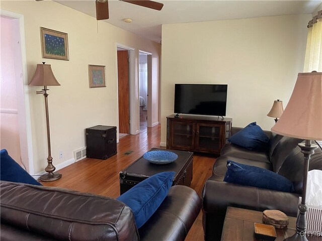 5180 Jamesville Rd, Dewitt, NY 13078 - living room with wood finished floors, a ceiling fan, and baseboards
