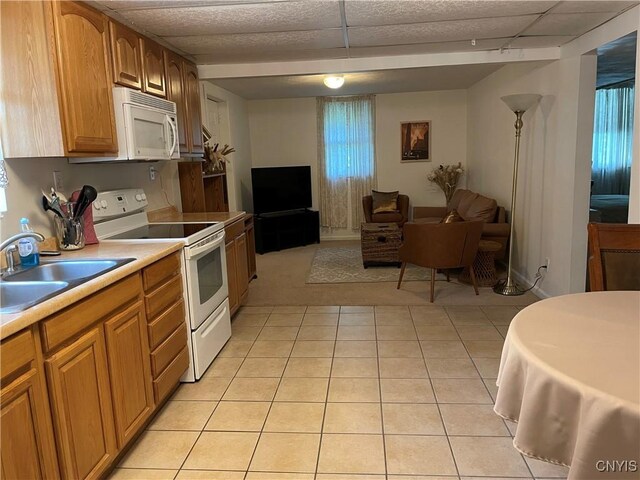 5180 Jamesville Rd, Dewitt, NY 13078 - kitchen with white appliances, open floor plan, a sink, light countertops, and light tile patterned floors