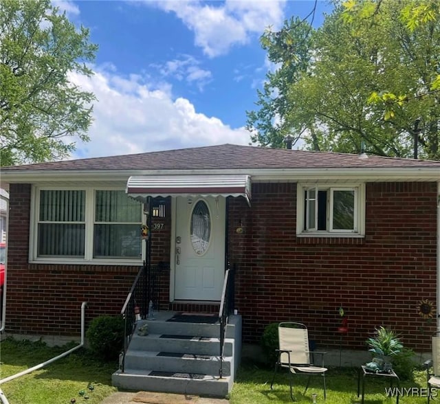 397 Broad St, Tonawanda-City, NY 14150 - view of front of property with brick siding, a front lawn, entry steps, and a shingled roof