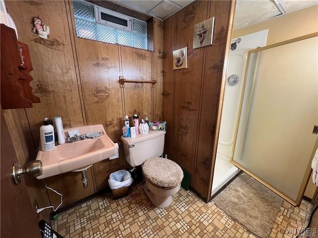 397 Broad St, Tonawanda-City, NY 14150 - bathroom with wooden walls, a shower stall, toilet, and a sink