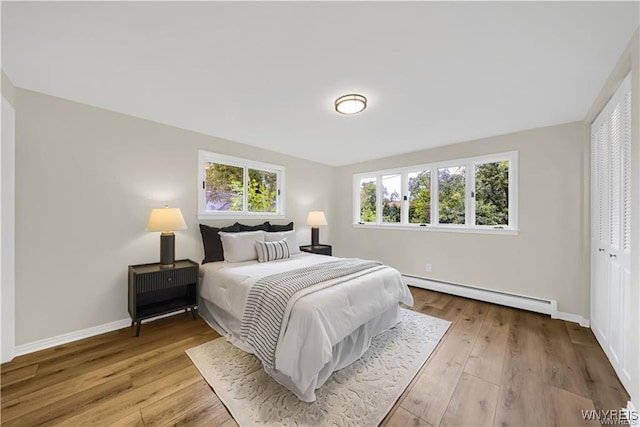 425 W Ln, Lewiston, NY 14092 - bedroom featuring baseboard heating, baseboards, and wood-type flooring