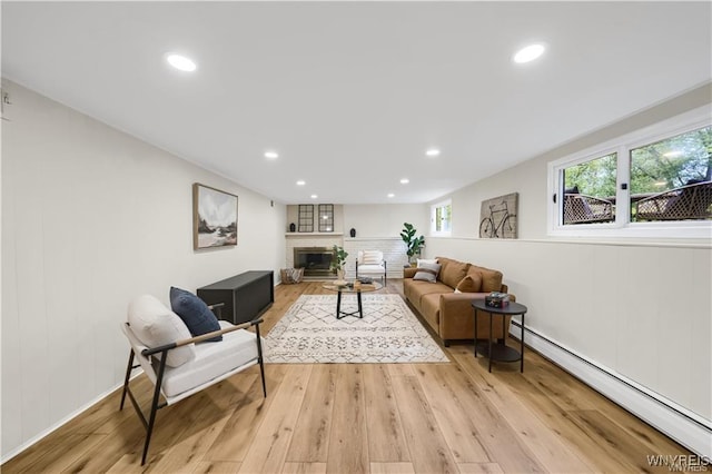 425 W Ln, Lewiston, NY 14092 - living room featuring a baseboard radiator, light wood finished floors, recessed lighting, and a fireplace