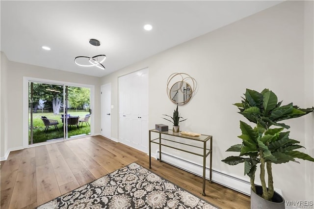 425 W Ln, Lewiston, NY 14092 - foyer with baseboard heating, baseboards, wood finished floors, recessed lighting, and a chandelier