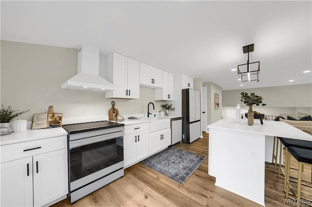 425 W Ln, Lewiston, NY 14092 - kitchen with wall chimney exhaust hood, white appliances, a sink, a kitchen breakfast bar, and light wood-style flooring