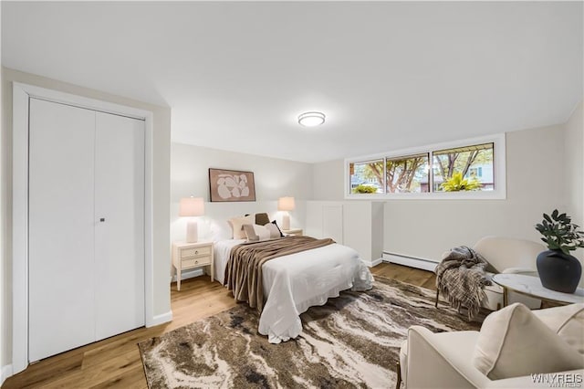 425 W Ln, Lewiston, NY 14092 - bedroom with baseboard heating, wood finished floors, and baseboards