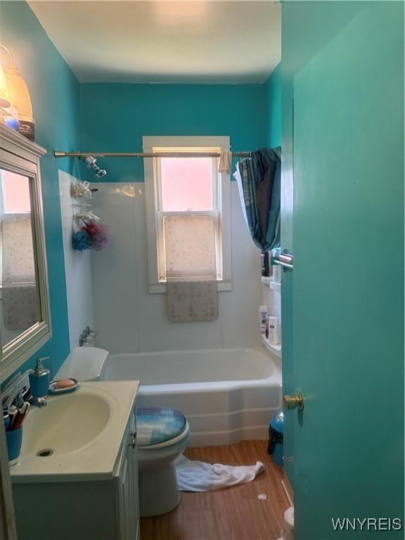 30 Woodell Ave, Cheektowaga, NY 14211 - full bathroom with vanity, toilet, wood finished floors, and shower / washtub combination