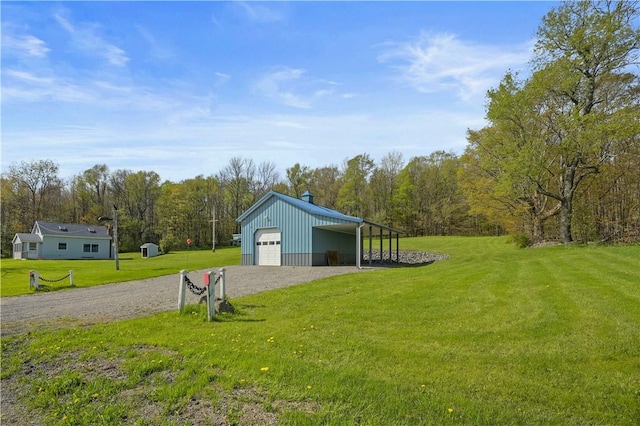 725 Arabia Rd, Summit, NY 12175 - view of green lawn featuring an outdoor structure, a detached garage, gravel driveway, and a view of trees