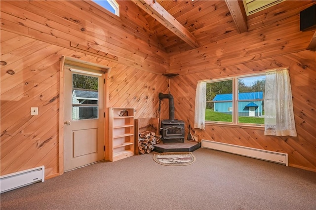 725 Arabia Rd, Summit, NY 12175 - unfurnished room with baseboard heating, a wood stove, a baseboard heating unit, carpet, and wooden walls
