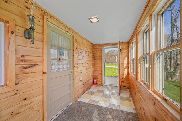 725 Arabia Rd, Summit, NY 12175 - doorway to outside with wooden walls and light colored carpet