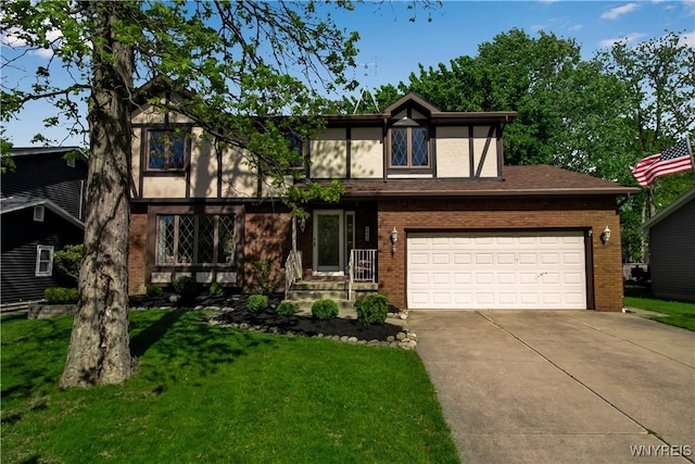 tudor home with driveway, a front lawn, a garage, and brick siding
