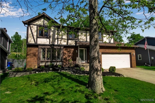 tudor-style house featuring brick siding, concrete driveway, and a front yard