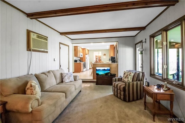 living room with light colored carpet, a wall mounted air conditioner, and beamed ceiling