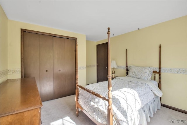 bedroom with a closet and light colored carpet