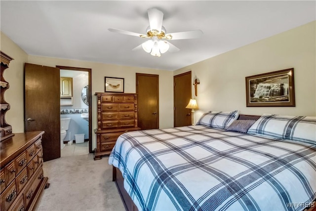 bedroom featuring light colored carpet, a closet, ceiling fan, and connected bathroom