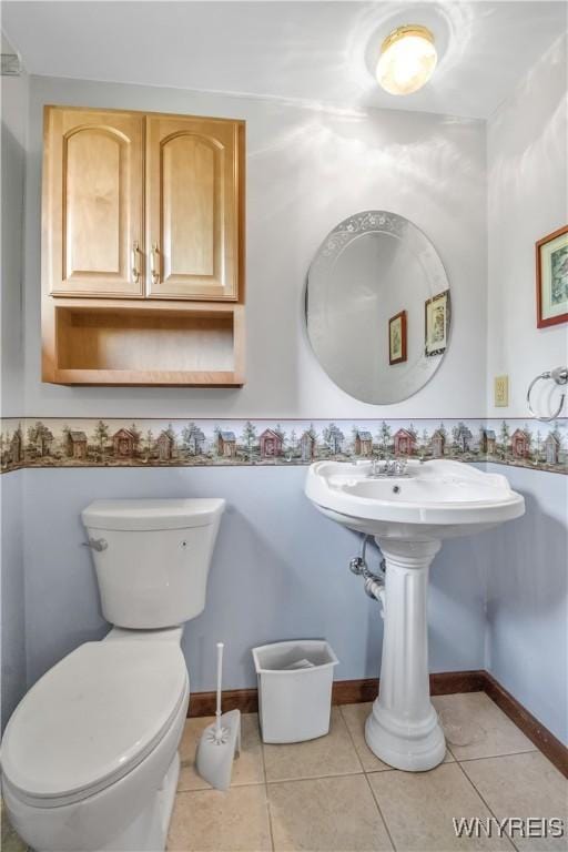 half bathroom with tile patterned flooring and toilet