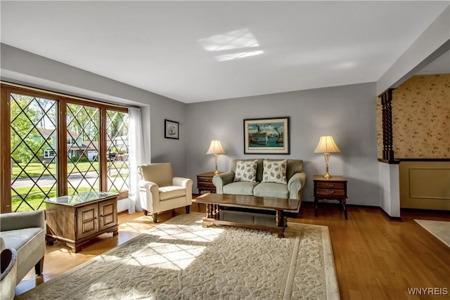 living area featuring light wood-type flooring and baseboards
