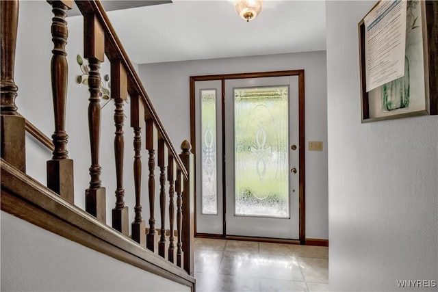 foyer with stairway and baseboards