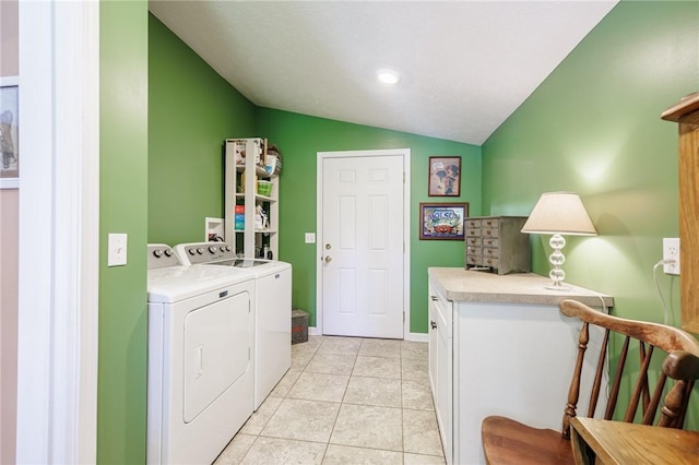 clothes washing area featuring washer and dryer and light tile patterned flooring