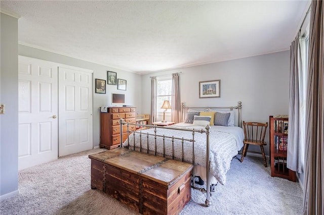 carpeted bedroom featuring crown molding