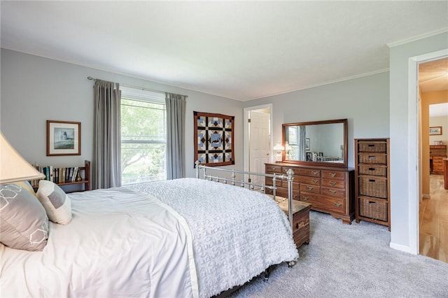 bedroom with carpet flooring, crown molding, and baseboards
