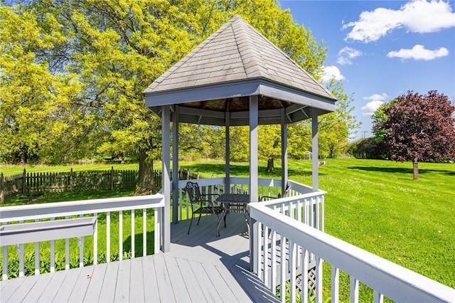 deck featuring a gazebo and view of scattered trees