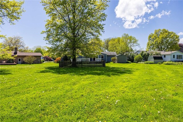 view of yard with a storage shed and an outdoor structure