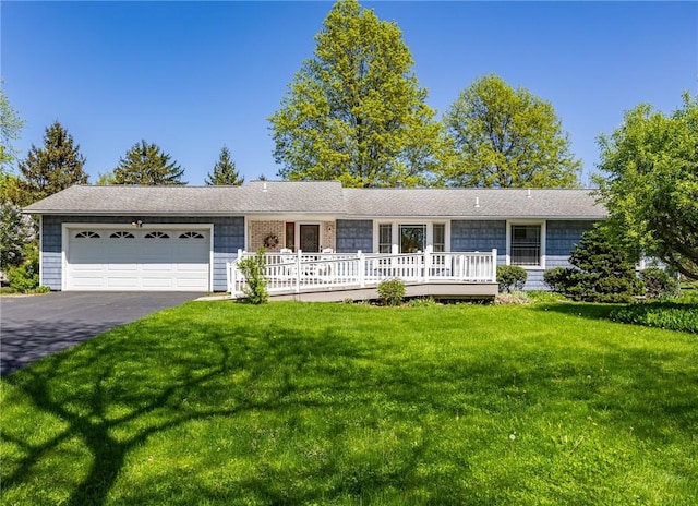 ranch-style home with an attached garage, a front yard, and driveway
