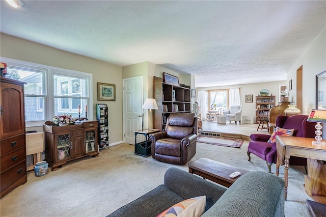 carpeted living area with baseboards