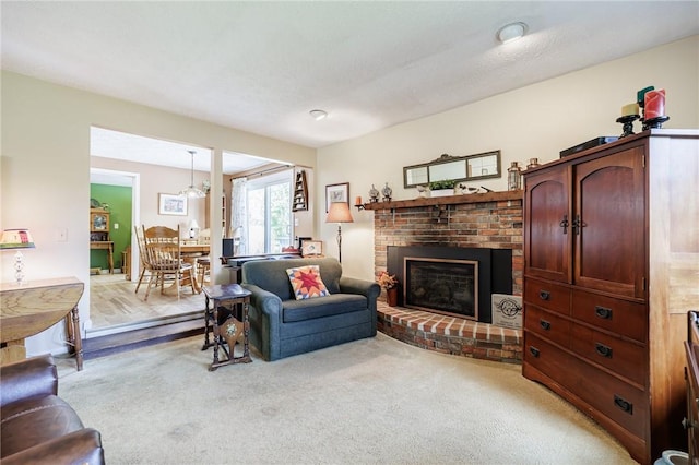 living room featuring a fireplace and light colored carpet