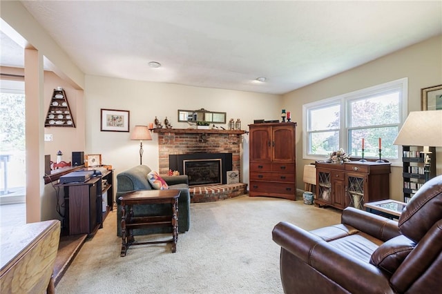 living room featuring light carpet and a fireplace