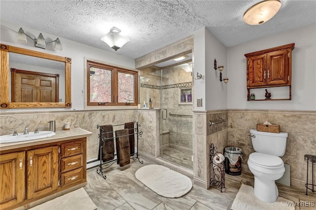 9811 Deer Creek Rd, Genesee, NY 14770 - full bathroom featuring tile walls, toilet, a shower stall, vanity, and a textured ceiling