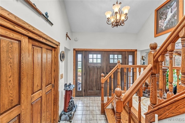 9811 Deer Creek Rd, Genesee, NY 14770 - entrance foyer featuring high vaulted ceiling, stairway, light tile patterned flooring, and a chandelier