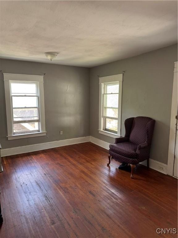 living area featuring hardwood / wood-style floors and baseboards