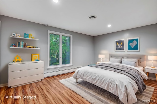 bedroom featuring a baseboard radiator, light wood finished floors, and recessed lighting